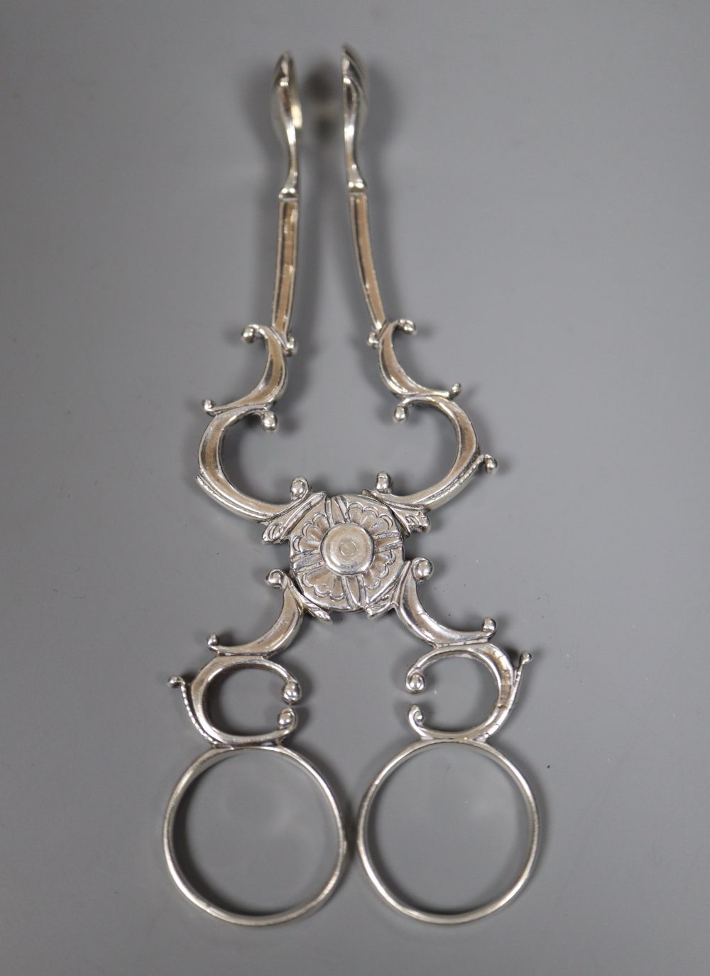 A set of three George III silver tablespoons, maker (probably) Thomas Dicks, London 1820 and a pair of George II silver sugar nips,